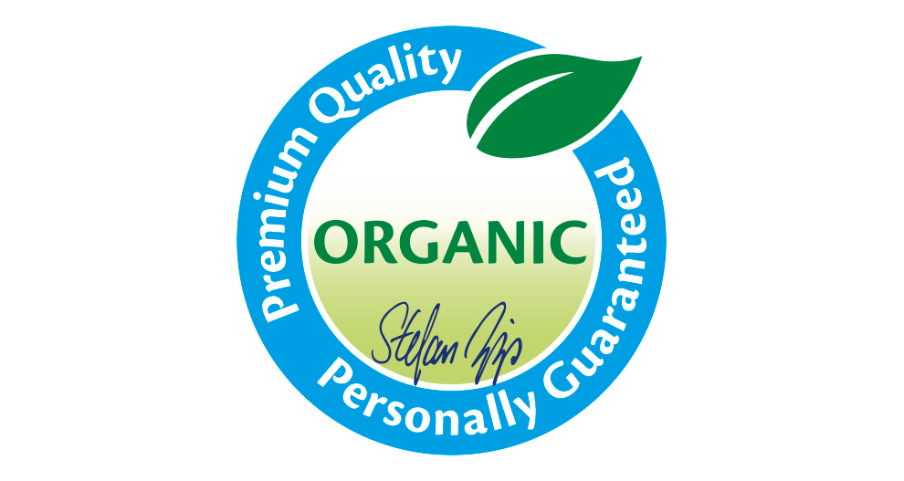 Ett cirkulärt märke med ordet "ORGANIC" i mitten, omgivet av orden "Premium Quality", "Personally Guaranteed" och en stiliserad bladgrafik.